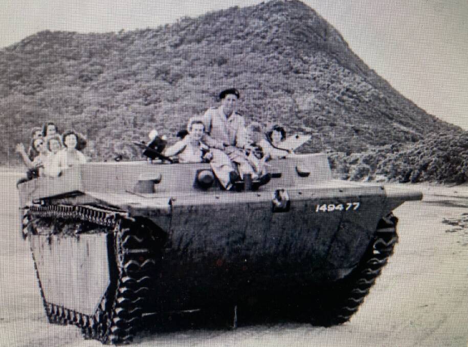 BEACH RIDE: An armoured personnel carrier ferries passengers on Shoal Bay Beach in the 1950s. Picture: Looking Back: Port Stephens