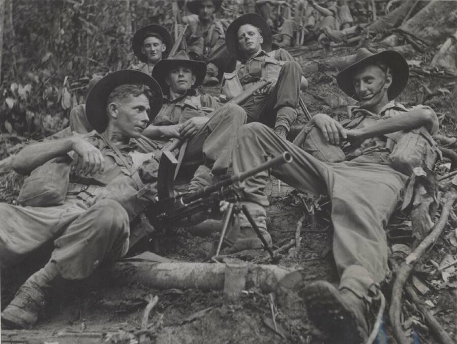 BRIEF STOP: An Australian infantry patrol rest on a jungle track in New Guinea.
Photo: University of Newcastle's Cultural Collections 