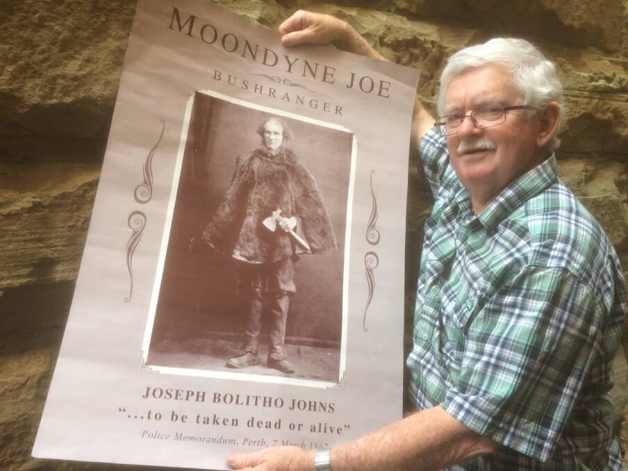 VIOLENT PAST: Lake Macquarie author Gregory Powell with a poster of notorious bushranger Moondyne Joe. Pictures: Mike Scanlon