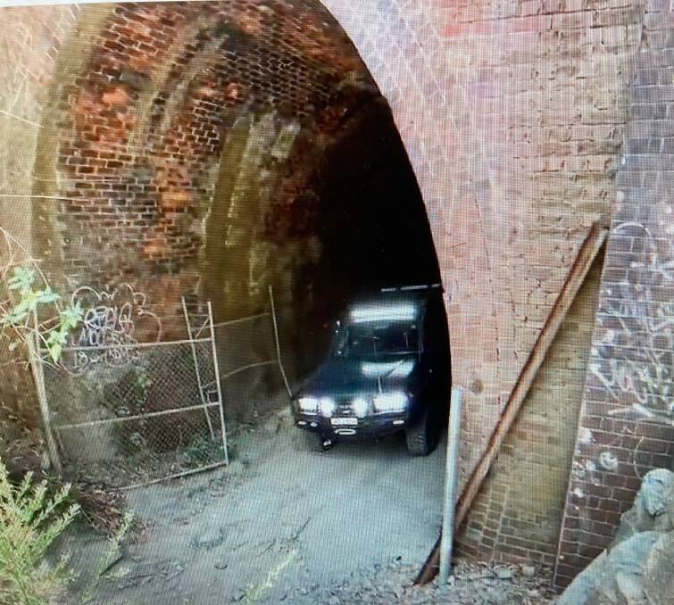 A 4WD emerges from one of the disused rail tunnels on the Sugarloaf Range.