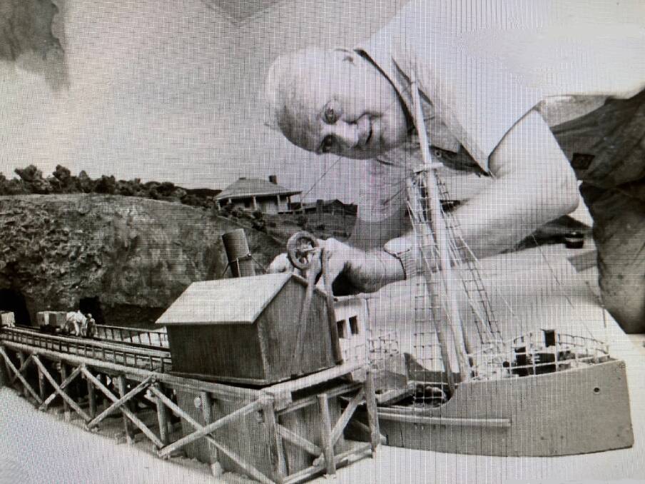 Life in miniature: Mick Jurd works on his model, circa 1977, of Catherine Hill Bay coal jetty. Pictures: Lake Mac Libraries 