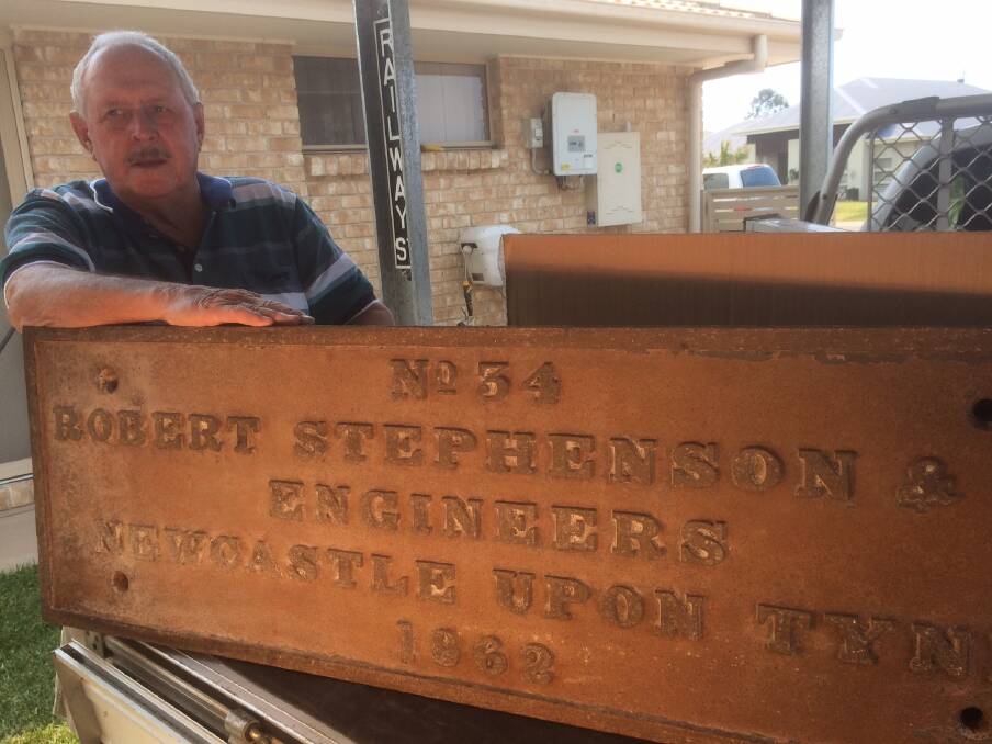 Rare find: Wayne Patfield with the nameplate believed to be from the old bridge over Hunter Street. Picture: Mike Scanlon