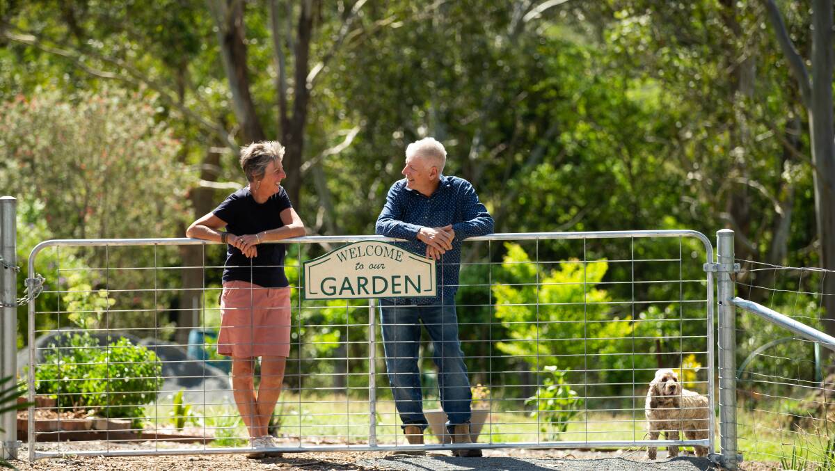 Gordon and Cheryl with Daisy at the gate of their Wingham acreage
