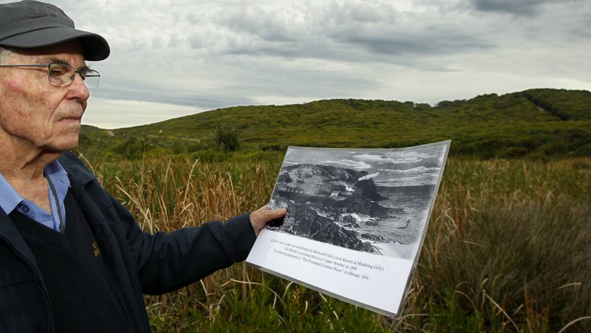 Then and now: John Shoebridge at Murdering Gully with a picture of what the copper smelter there once looked like.

