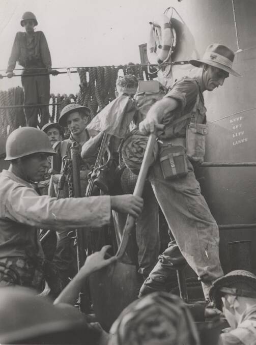 READY TO GO: Australian soldiers disembark on Labuan Island, Borneo, June 20, 1945. Image: University of Newcastle's Cultural Collections