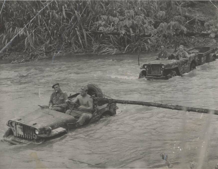 MOBILE WORKSHOPS: Australian Jeeps carrying spare parts for Matilda tanks cross a river in Bougainville. Image: University of Newcastle's Cultural Collections