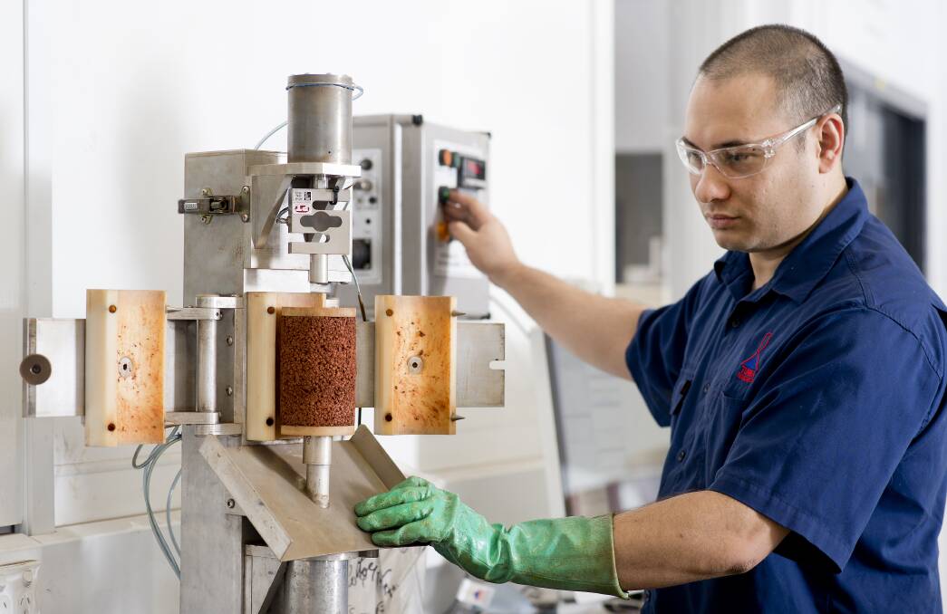 ADVANCING INDUSTRY: Iron ore flow testing conducted in the Bulk Solids laboratory.
