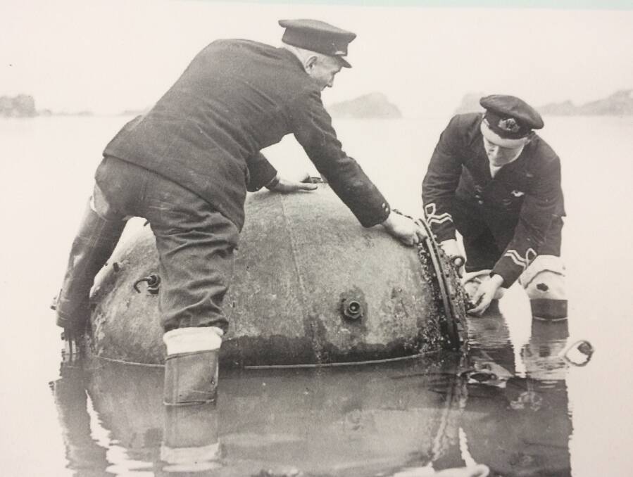Grim find: A sea mine being made safe by officials after being washed ashore in 1940.