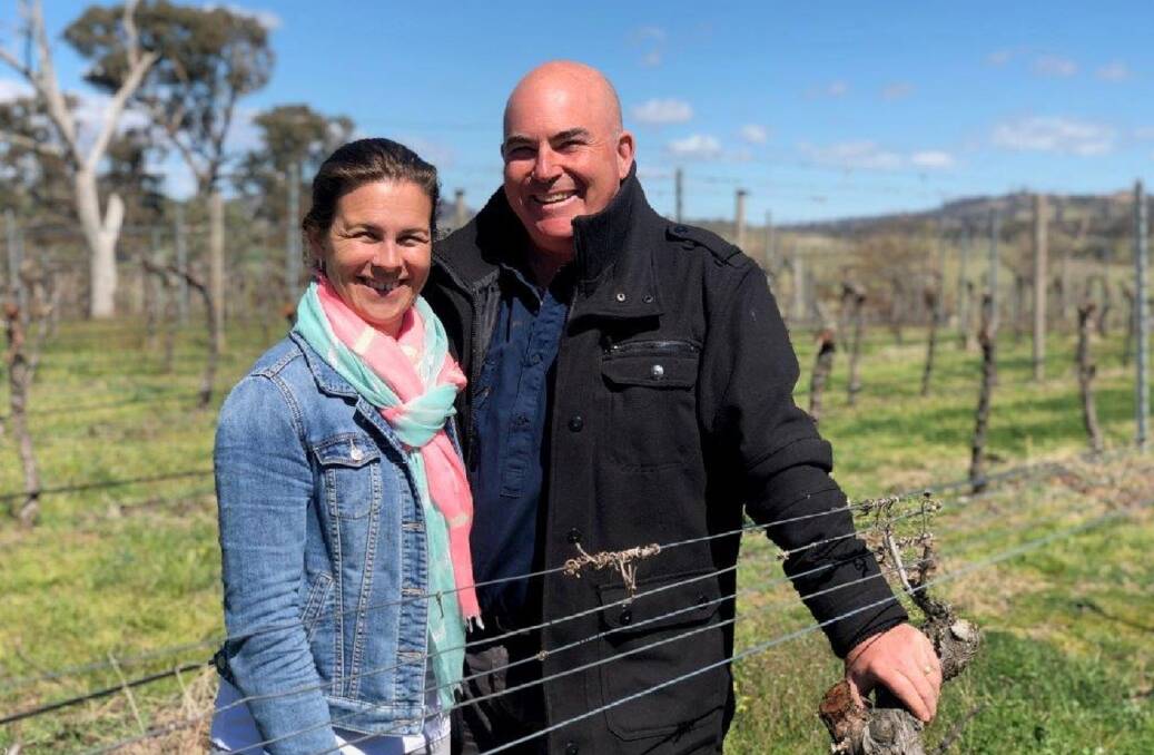 EXCITING: Jason and Alecia Brown in their recently purchased Kerralee vineyard on the Barton Highway.