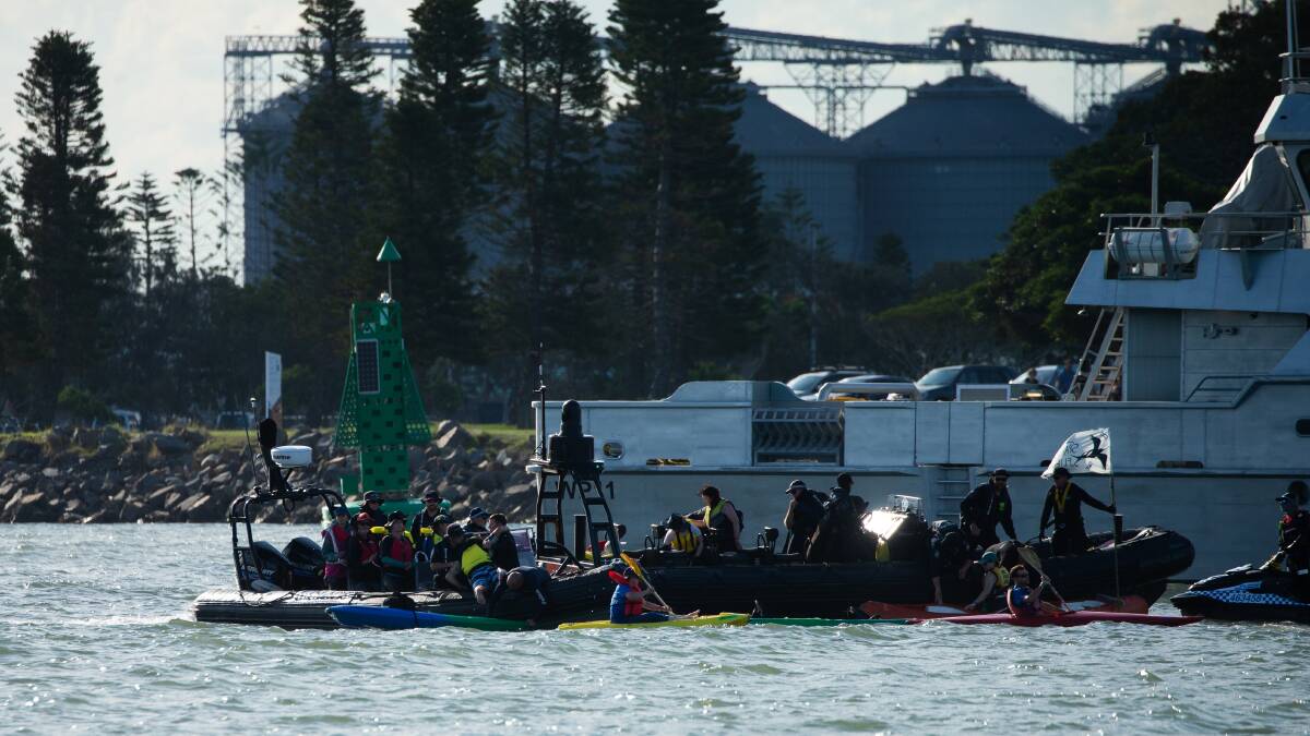 Rising Tide members are arrested during the protest on Newcastle harbour late last year. Picture by Jonathan Carroll