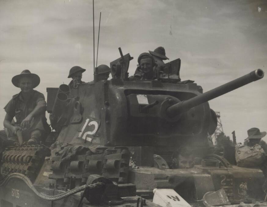 DOMINANT FORCE: A Matilda tank and infantrymen passengers in Labuan Island, Borneo. Image: University of Newcastle's Cultural Collections