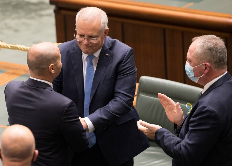 MONEY MATTERS: Scott Morrison and Barnaby Joyce congratulate Treasurer Josh Frydenberg after delivering the federal budget. Picture: Sitthixay Ditthavong