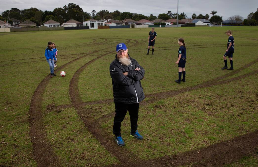 HEARTBREAKING: New Lambton Football Club president Steve Manning and players on the damaged oval. Picture: Marina Neil