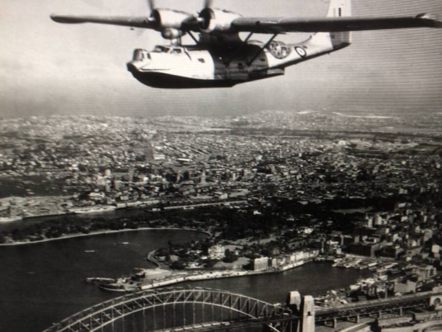 FLYING HIGH: A Catalina flies over the Sydney Harbour bridge, possibly in 1946. Pictures: Supplied