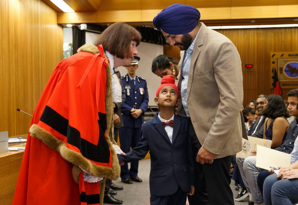 WELCOME: Biragam Singh and his father Balwinder Singh Sidhu receive their citizenship certificates from mayor Kay Fraser. Picture: Max Mason-Hubers