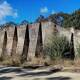 Strange sight: The massive mystery wall in Fern Bay bushland today once played a key role in WWII. Pictures: Fortress Newcastle
