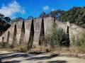 Strange sight: The massive mystery wall in Fern Bay bushland today once played a key role in WWII. Pictures: Fortress Newcastle