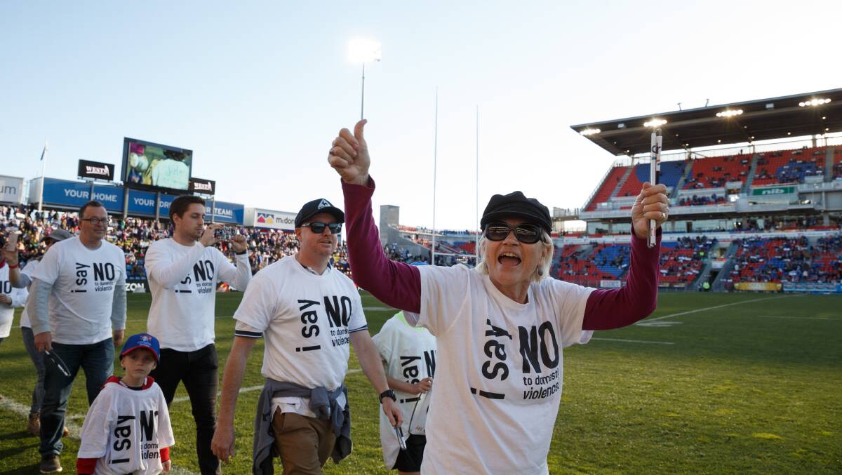 LEADING THE CHARGE: Helen Cummings takes part in the Got Your Back Sista "Say No To Domestic Violence" demonstration at half time in the Newcastle Knights game against the Gold Coast Titans at McDonald Jones Stadium. Picture: Max Mason-Hubers 