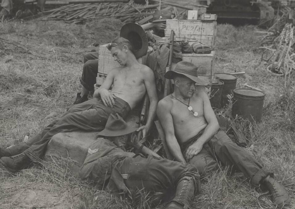 SHUT-EYE: Aussie soldiers on Labuan Island (Brunei Bay) sleep after a night of loading ammunition and food at Landing Beach. Image: University of Newcastle's Cultural Collections
