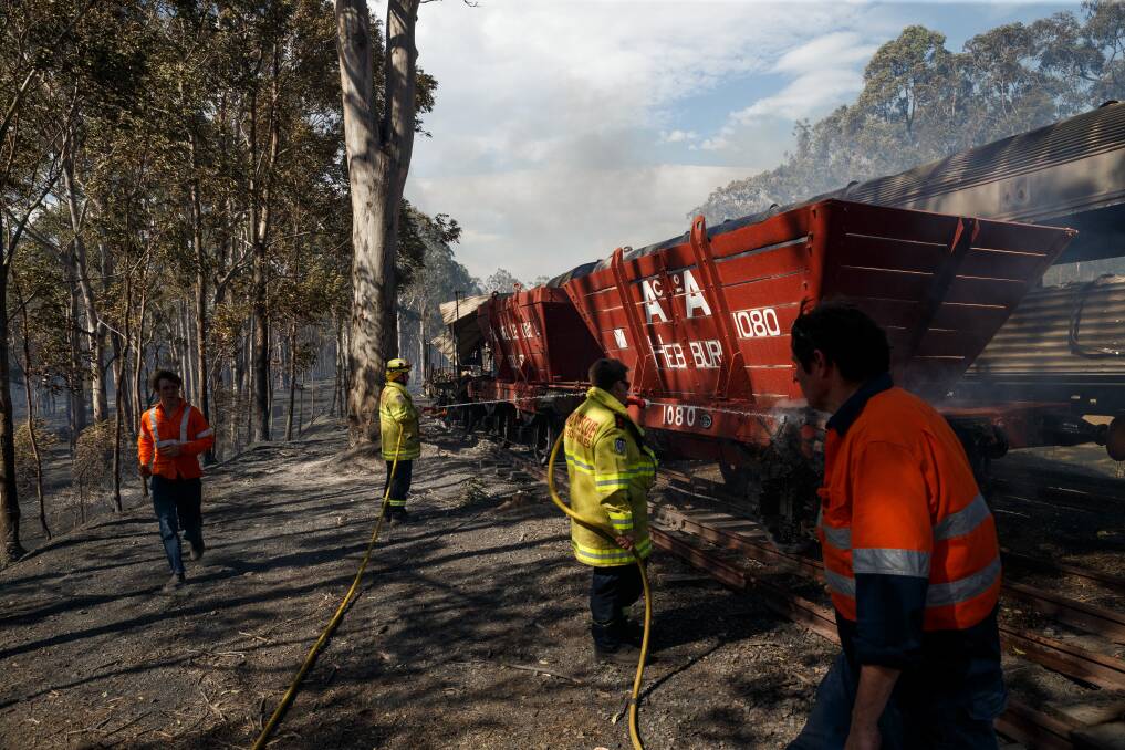 Hard hit: Crews attend to smouldering rail relics at Richmond Vale Railway Museum in September 2017. Picture: Max Mason-Hubers