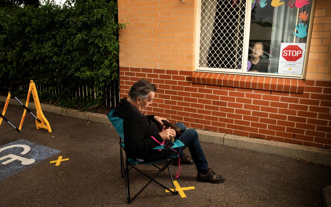 ISOLATED: John Neil visits his wife, Hetty, at Uniting Lindsay Gardens aged care home at Hamilton in April. Picture: Marina Neil