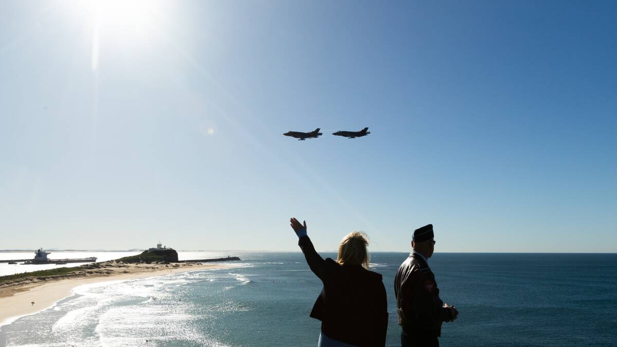 Lord mayor Nuatali Nelmes and Air Commodore Micka Gray watch two jets fly over the air show launch on Friday. Picture by Jonathan Carroll