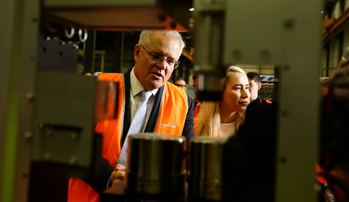 ON THE GAS: Scott Morrison inspects a hydrogen battery at Tomago firm Ampcontrol. Picture: Jonathan Carroll