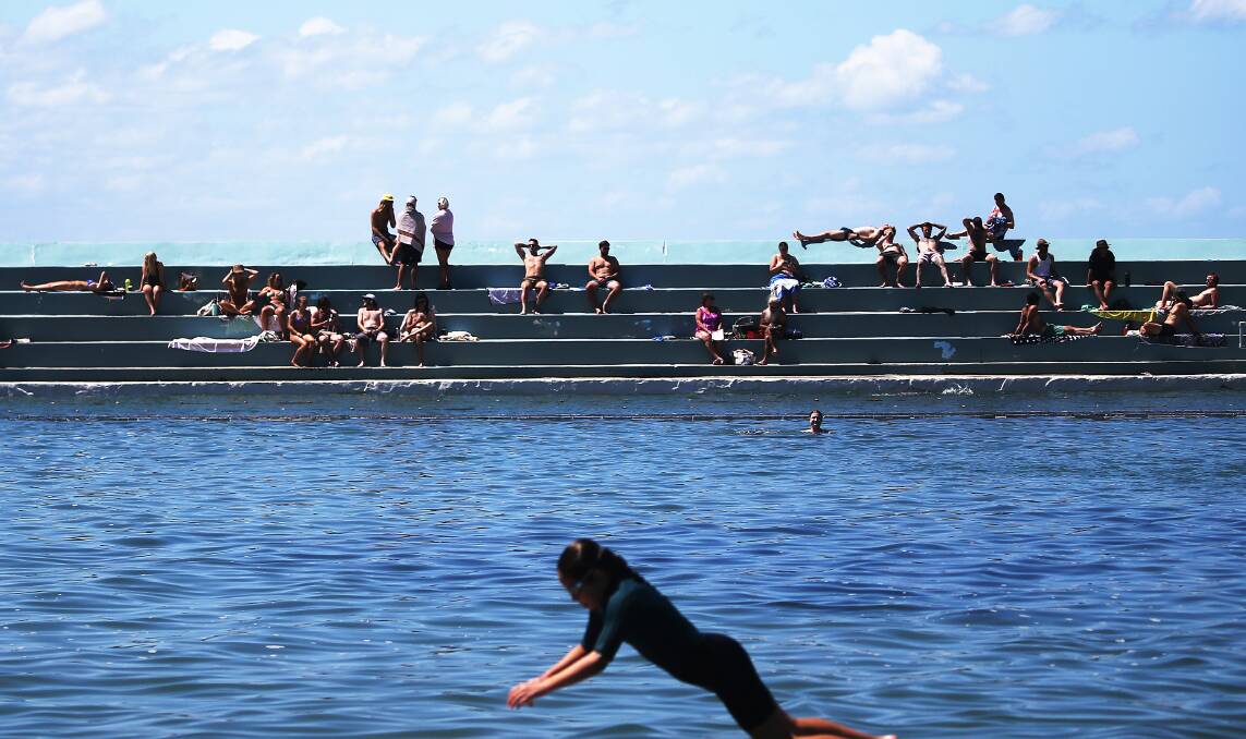 OUT AND ABOUT: A crowd enjoys the post-lockdown sunshine at Newcastle Ocean Baths on Saturday. Picture: Peter Lorimer