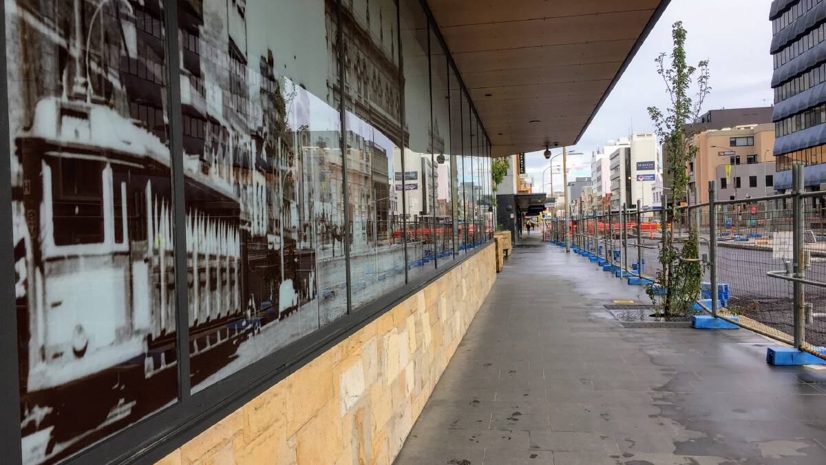 The old Hunter Street tram pictured on Newcastle's new courthouse, left, next to new light-rail construction. Picture: Michael Parris 