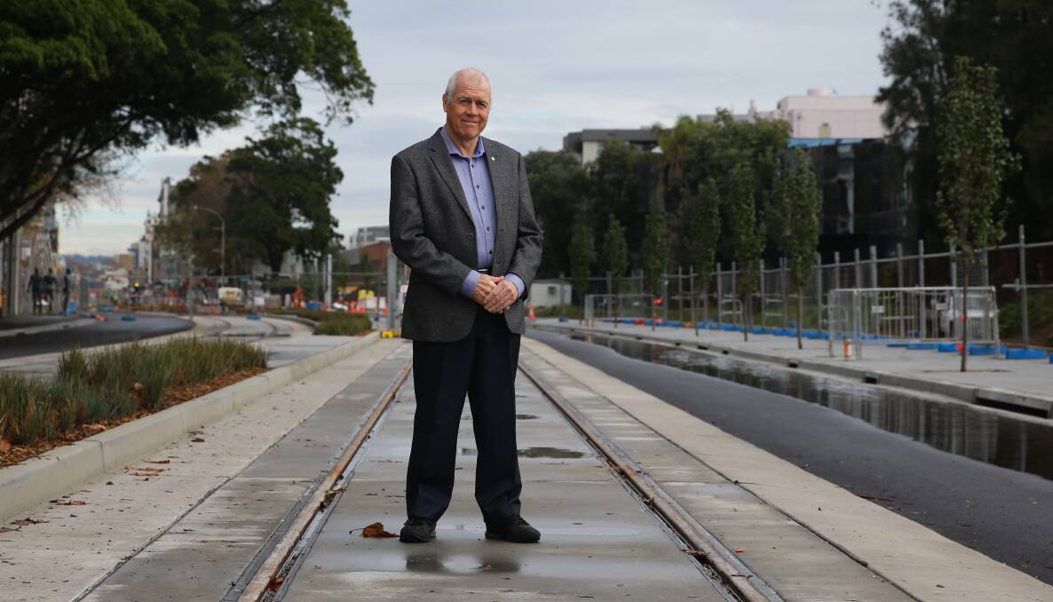 POSITIVE: Steve O'Connor standing on the newly completed section of light rail track in Scott Street. Picture: Jonathan Carroll