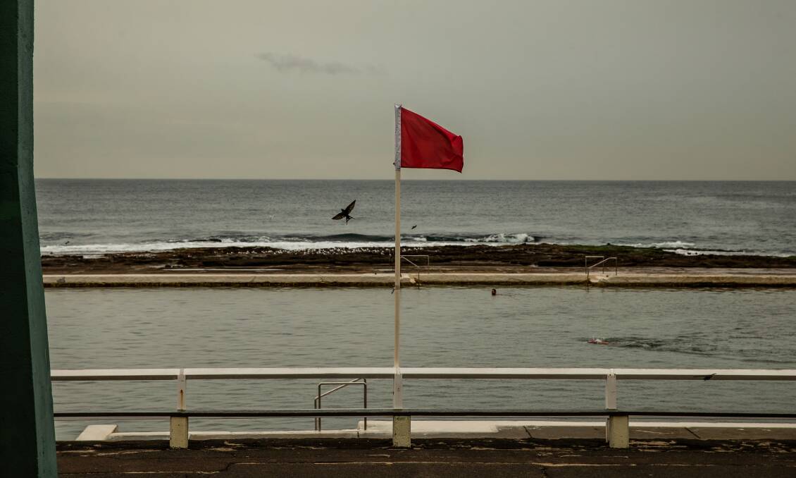 CLOSED: A red flag at Newcastle Ocean Baths on Monday. Picture: Marina Neil