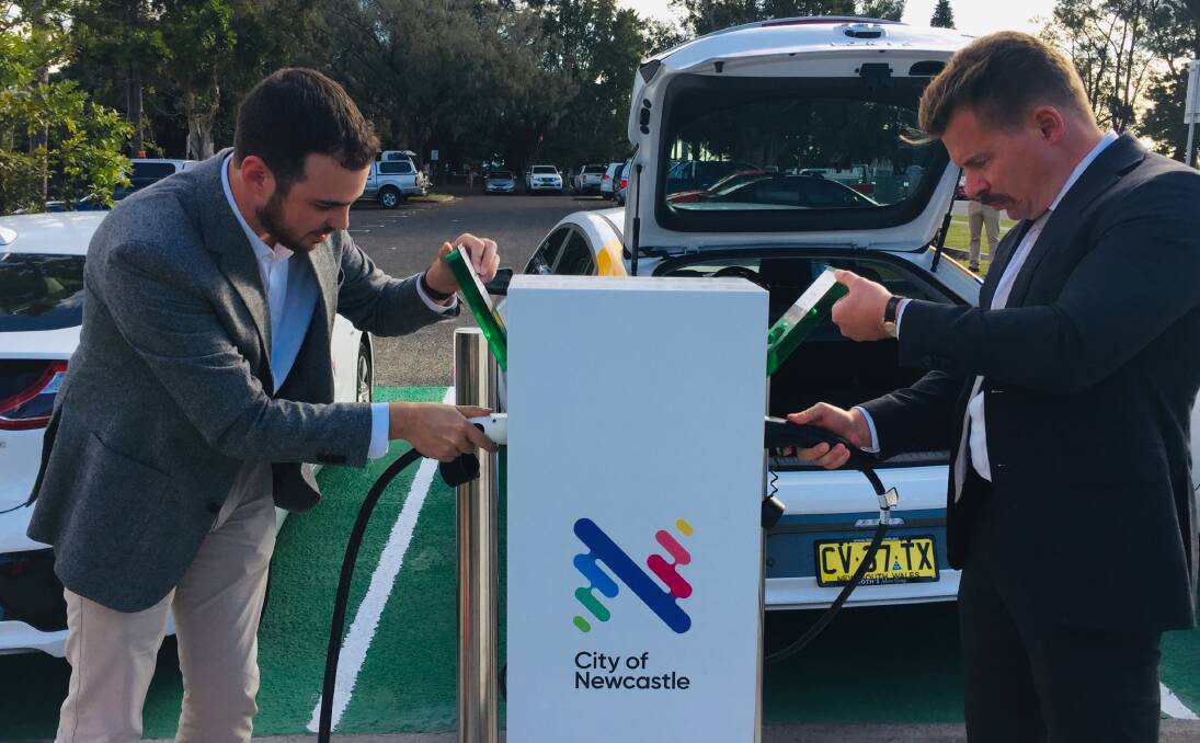 PLUGGED IN: Deputy lord mayor Declan Clausen and Port of Newcastle chief commercial officer Simon Byrnes fill up at the new charging station in Wharf Road.