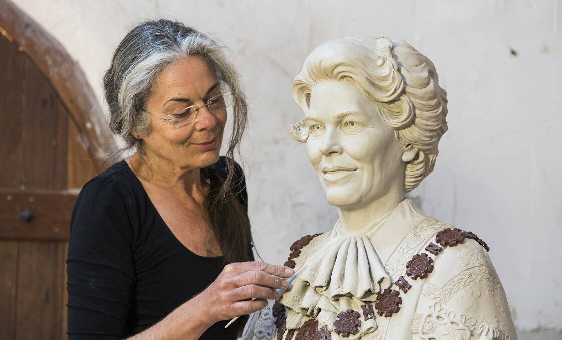FINISHING TOUCHES: Sculptor Margot Stephens works on the Joy Cummings statue in her Mudgee studio. Picture: Amber Hooper
