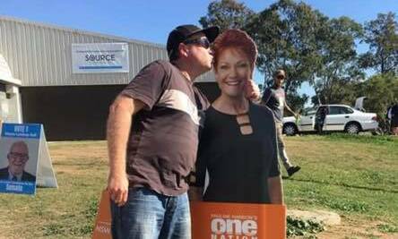 SUPPORT: A Hunter voter plants a kiss on a Pauline Hanson cut-out on election day.