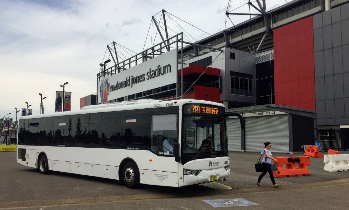 SERVICE: A woman steps off a park-and-ride shuttle bus at Hunter Stadium.