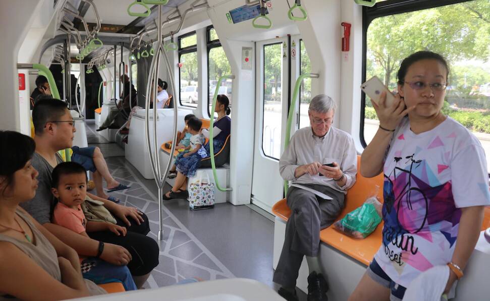 Professor Peter Newman on board a trackless tram in China.
