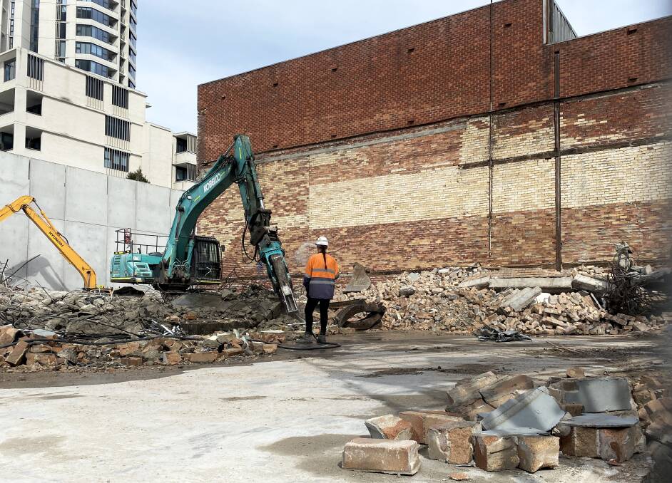 Workers finish demolishing the Musos Corner building in National Park Street. The shop has moved across the road and will shift to new permanent digs in Parry Street next year. Picture: Peter Lorimer