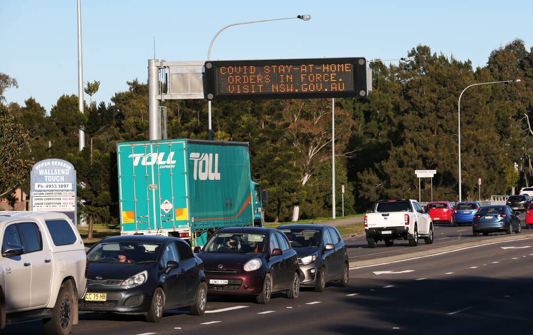 ON THE MOVE: A traffic sign at Wallsend warning motorists about stay-at-home restrictions. Hunter politicians and senior government minister Andrew Constance have warned that travelling Sydney workers risk spreading the virus to regional NSW. Picture: Geoff Jones