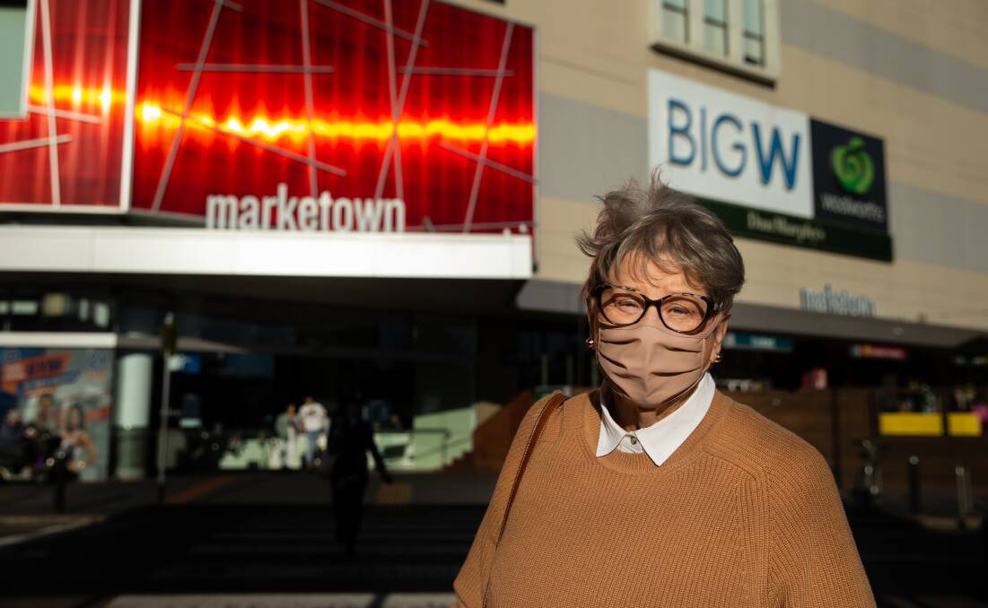 COVERED: Merewether's Susan Ebrill outside Marketown on Friday. She visited Sydney almost two weeks ago and is now following public health orders to wear a mask. Picture: Marina Neil