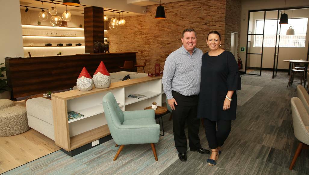 HAPPIER TIMES: Brett Dann and wife Louise after a multimillion-dollar renovation of the Helloworld Travel store in Hunter Street. 