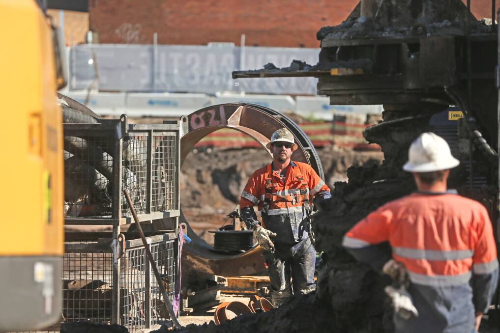 KEEPING BUSY: Construction workers at the Store redevelopment site in Newcastle West. The building industry is now the Hunter's second-biggest employer, but housing approvals are falling. Picture: Marina Neil