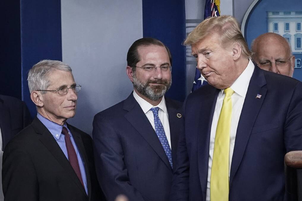 US National Institute of Allergy and Infectious Diseases director Dr Anthony Fauci, left, with Donald Trump at the White House briefing on Tuesday. Images
