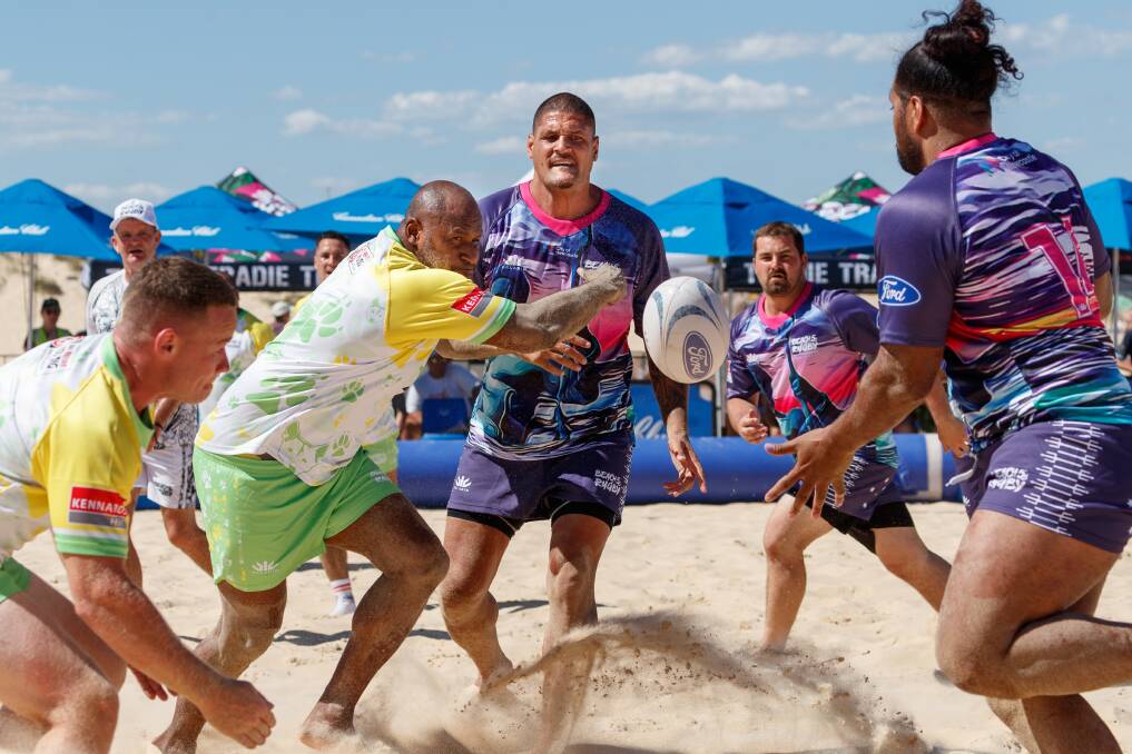 GAME ON: Lote Tuqiri and Willie Mason playing at the Beach 5s tournament at Nobbys. Picture: Max Mason-Hubers