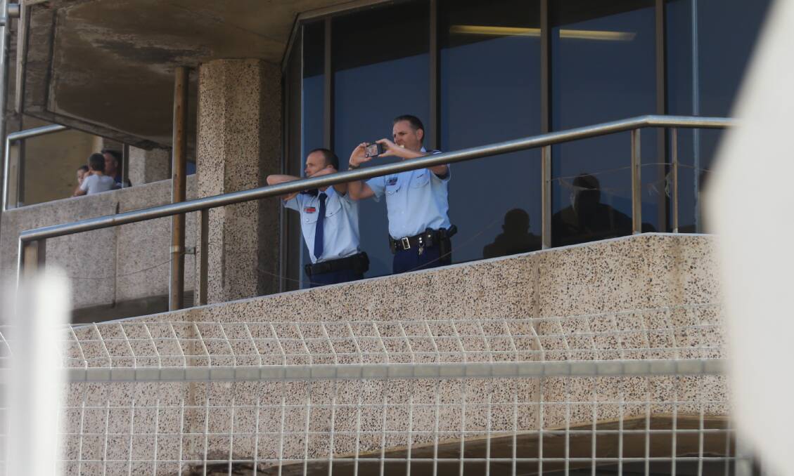 Police watch the race from the balcony of their headquarters in Watt Street. Picture: Jonathan Carroll