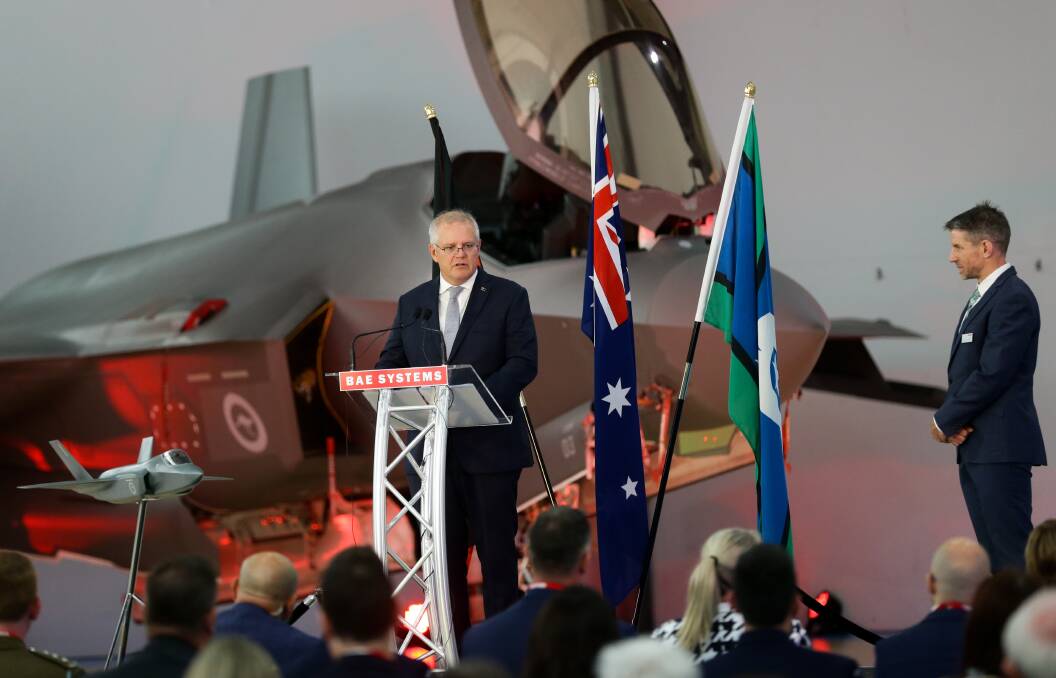Scott Morrison talks in front of an F-35 inside a BAE Systems hangar at Williamtown on Monday. Picture: Jonathan Carroll 