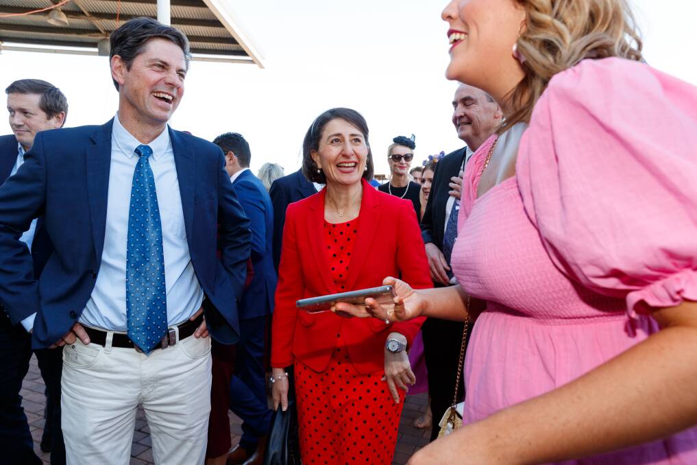 SURPRISE VISIT: Gladys Berejiklian walks with Nationals candidate Dave Layzell through the crowd at the Scone Cup on Friday. Picture: Max Mason-Hubers