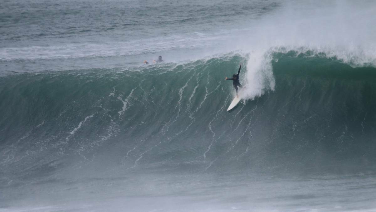 MAKING THE DROP: A surfer takes on a big wave at Merewether in May last year. Picture: Dave Anderson