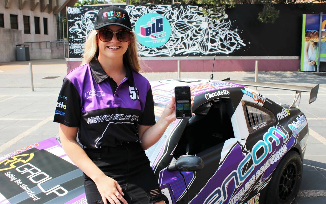 LAUNCH: Warners Bay racing car driver Charlotte Poynting displays the City of Newcastle mobile app in Wheeler Place on Thursday.