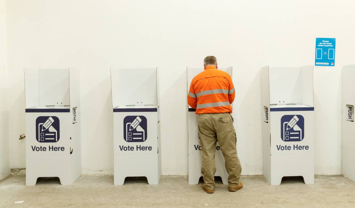 GETTING IN EARLY: A voter casts his ballot in Muswellbrook on Friday. Picture: Max Mason-Hubers
