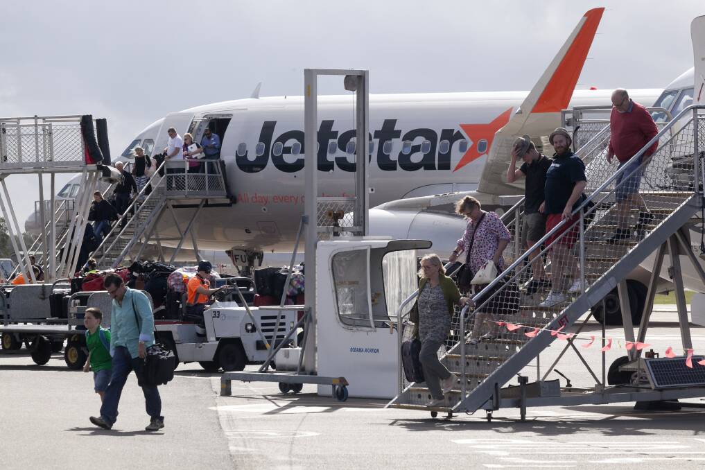GETTING BUSY: Passengers exit a plane on the tarmac at Newcastle Airport, which has plans for a $147 million expansion and a commercial precinct.